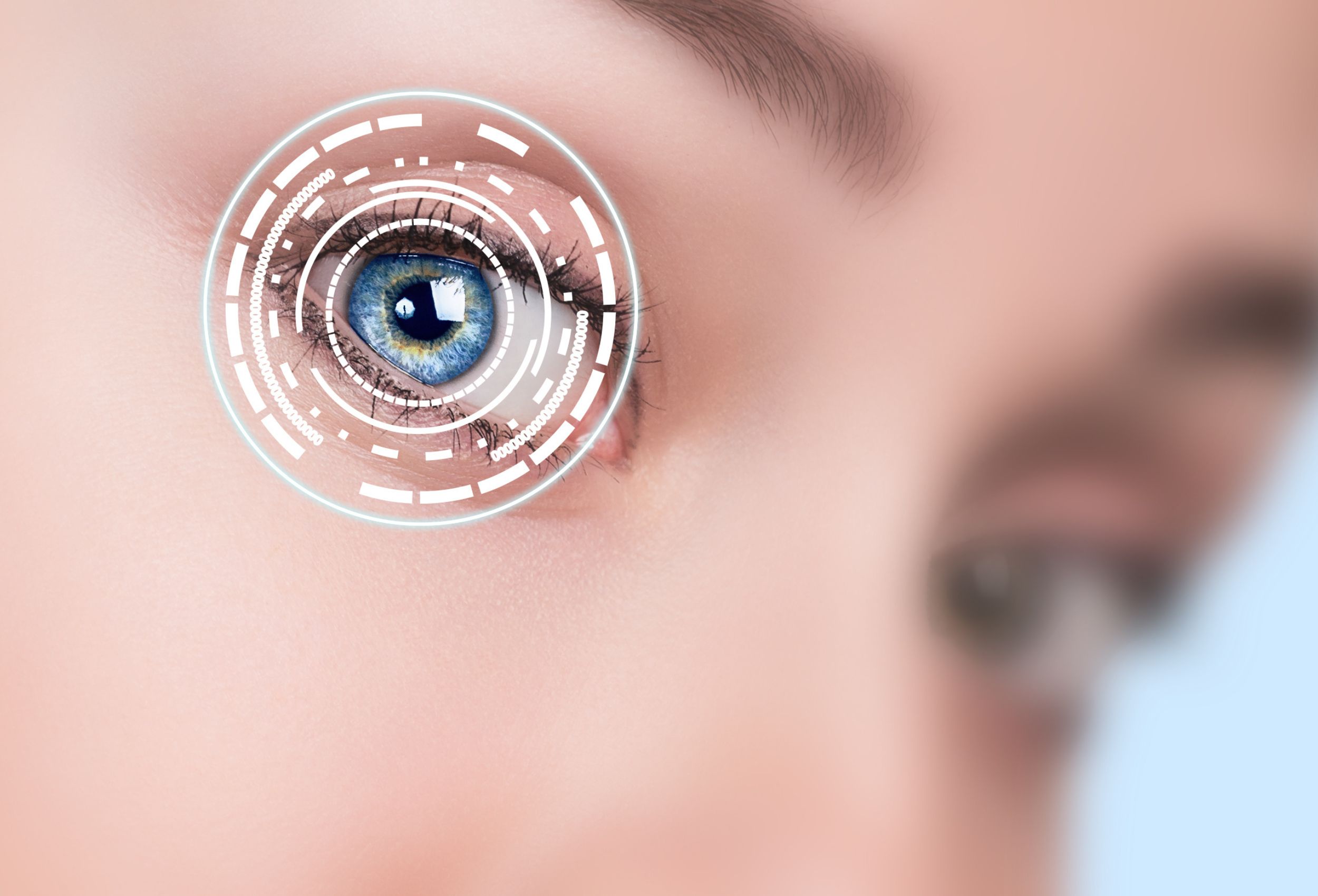close up of a person's face with a circular futuristic design over one eye